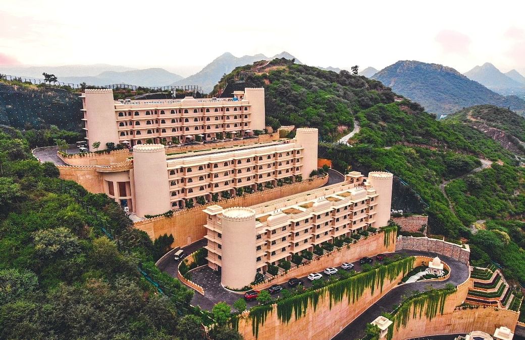 Perceptive Ideas Consulting Engineers Pvt. Ltd., a design-first structural engineering consultancy, has once again demonstrated its expertise through the structural design of Aurika – Luxury by Lemon Tree, Udaipur. Nestled within the rugged Aravalli hills, the project exemplifies the firm’s commitment to integrity, innovation, and professionalism, transforming one of the region’s most challenging terrains into an iconic hospitality landmark.

As the Structural Design Consultant, Perceptive Ideas addressed the steep gradients, undulating contours, and variable geological strata of the Aravallis. Instead of extensively reshaping the hills, the team adopted a terraced structural planning approach, enabling the built form to blend naturally with the landscape. This strategy preserved slope stability, minimized excavation, and maintained architectural harmony.

Given the complex geology—characterized by weathered rock, inconsistent SBC pockets, and local shear zones—the firm developed a comprehensive piling strategy. This included deep piles, isolated and combined pile caps on steep slopes, rock-socketed piles where refusal strata existed, and rigorous pile load and integrity testing. These measures ensured uniform load distribution and long-term structural performance across varying site elevations.

Hill stabilization was another critical focus. The team implemented engineered granular backfilling, touch piles for vertical members, retaining structures with shear keys, and geogrid-based soil confinement. Extensive retaining systems, including counterfort RCC walls, soil-nailed solutions for deep cuts, staged excavation, and robust drainage mechanisms, were employed to mitigate hydrostatic pressure and ensure slope stability throughout construction.

Terrain-driven solutions extended to the superstructure as well. Voids were created between column foundations to avoid unnecessary soil filling, column spacing was optimized to minimize hill disturbance, and columns were strategically placed to reduce pile dependency. Every decision emphasized safety, constructability, and alignment with architectural intent.

Reflecting on the project, Mr. Ajay Gupta, Principal Consultant & Founder of Perceptive Ideas, said,
"Aurika Udaipur is a testament to engineering that respects and responds to nature. Designing amidst the Aravallis was a challenge that demanded precision, sensitivity, and innovation. We aimed to create a strong structure that harmonizes with its surroundings, and we are proud to have delivered a landmark that embodies resilience and elegance."

Carved into the Aravalli hills, Aurika Udaipur now stands as a remarkable feat of engineering, defined by meticulous analysis, state-of-the-art construction techniques, and unwavering commitment to long-term safety and performance. Through every structural intervention aligned to architectural vision, Perceptive Ideas has set a new benchmark for hillside hospitality engineering in India.